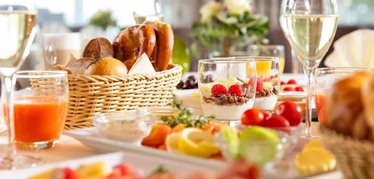 Elegantly set table with fine dining presentation—representing the gastronomic hospitality and attention to guest experience central to the hotel's philosophy.