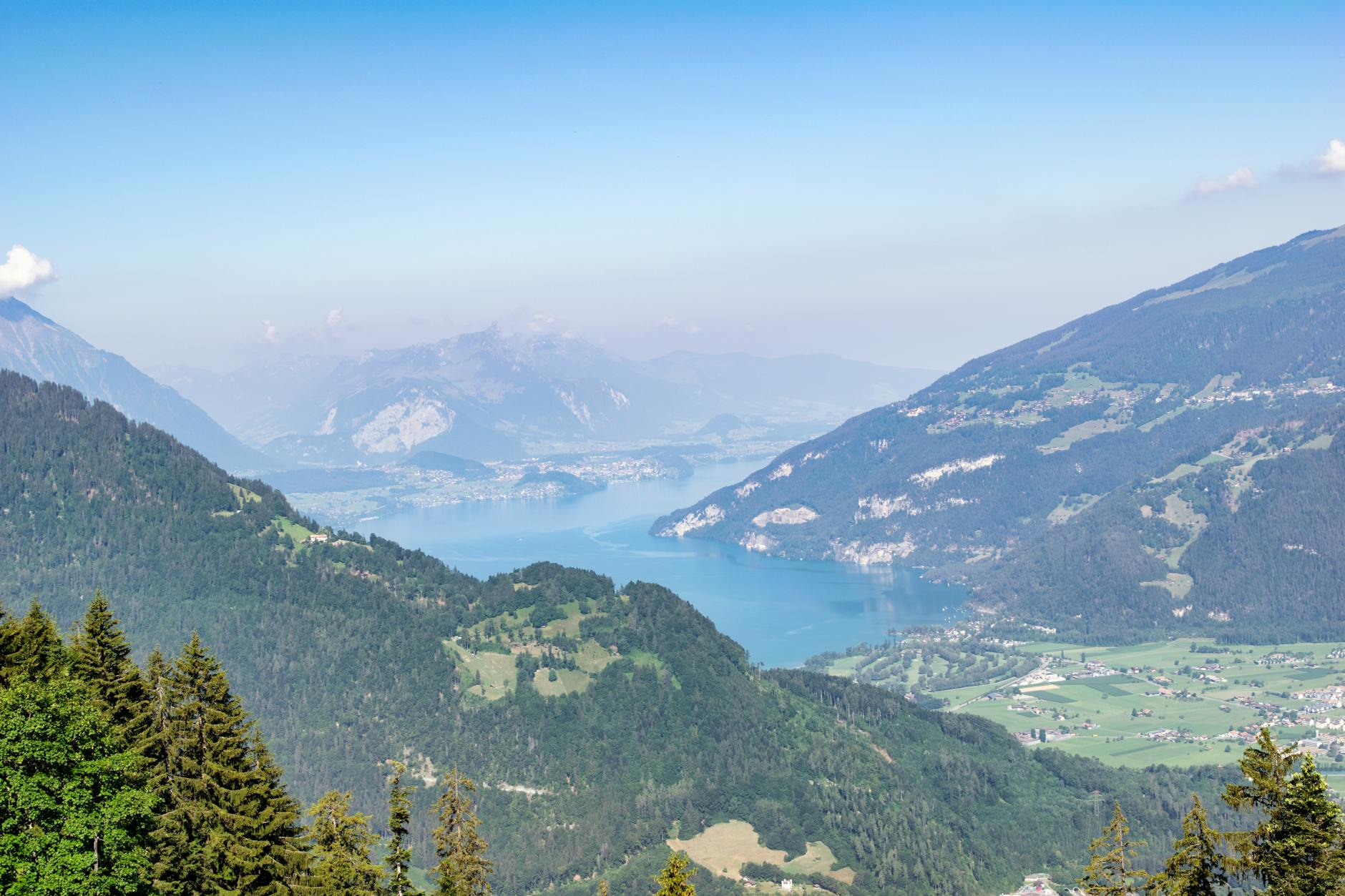 Ein luxuriöses Wellnesshotzimmer mit Blick auf die Schweizer Alpen, ausgestattet mit einem modernen Infinity-Pool und eleganten Holzelementen.