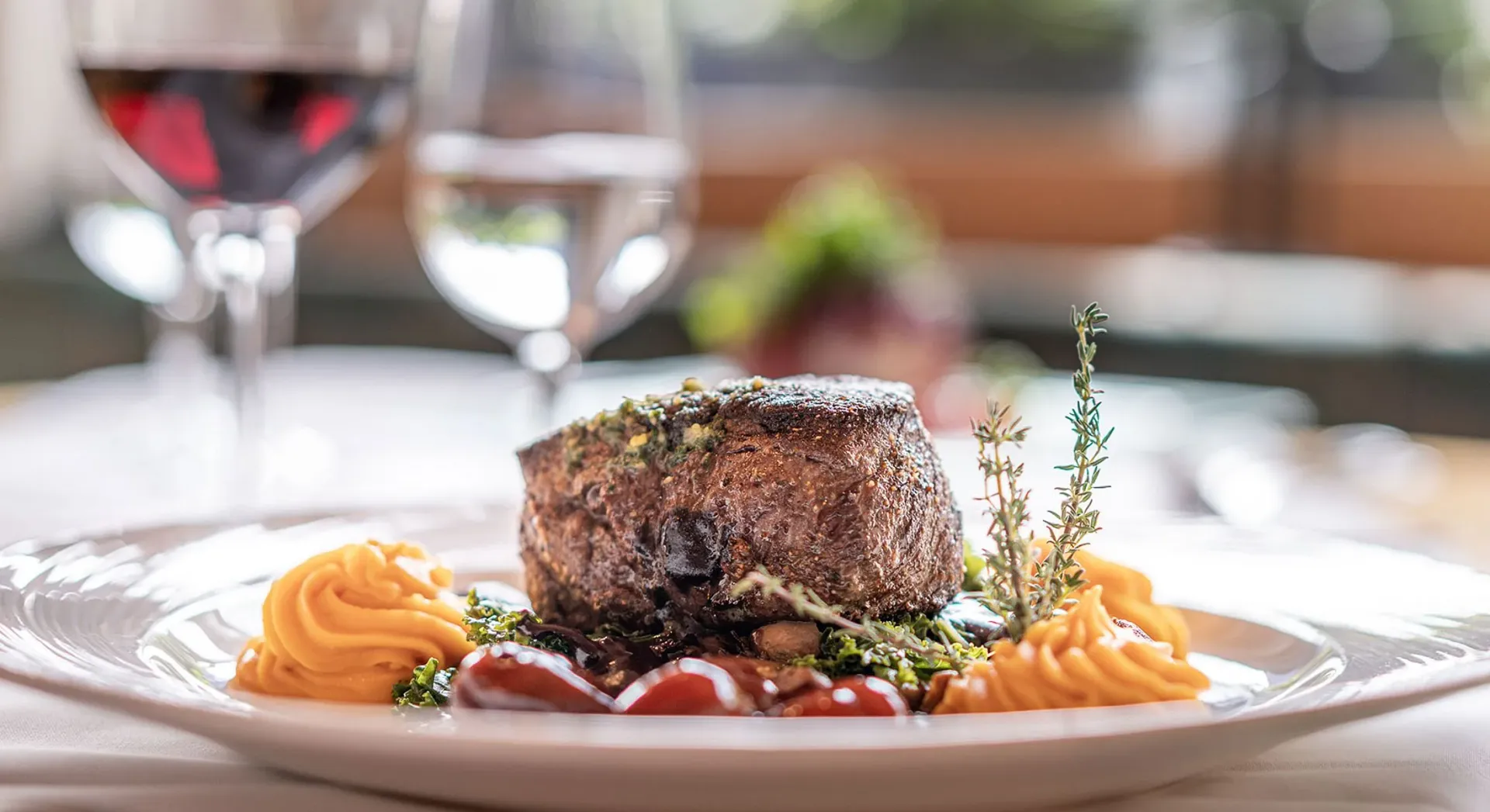 A beautifully plated beef medallion with red wine reflects the fine dining and culinary heritage celebrated at Hotel Bellaval's restaurant.